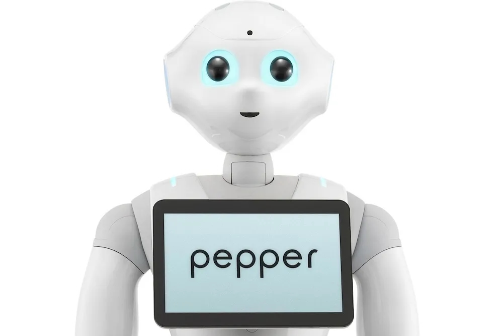 Pepper, a white humanoid robot with a tablet on its chest reading pepper.