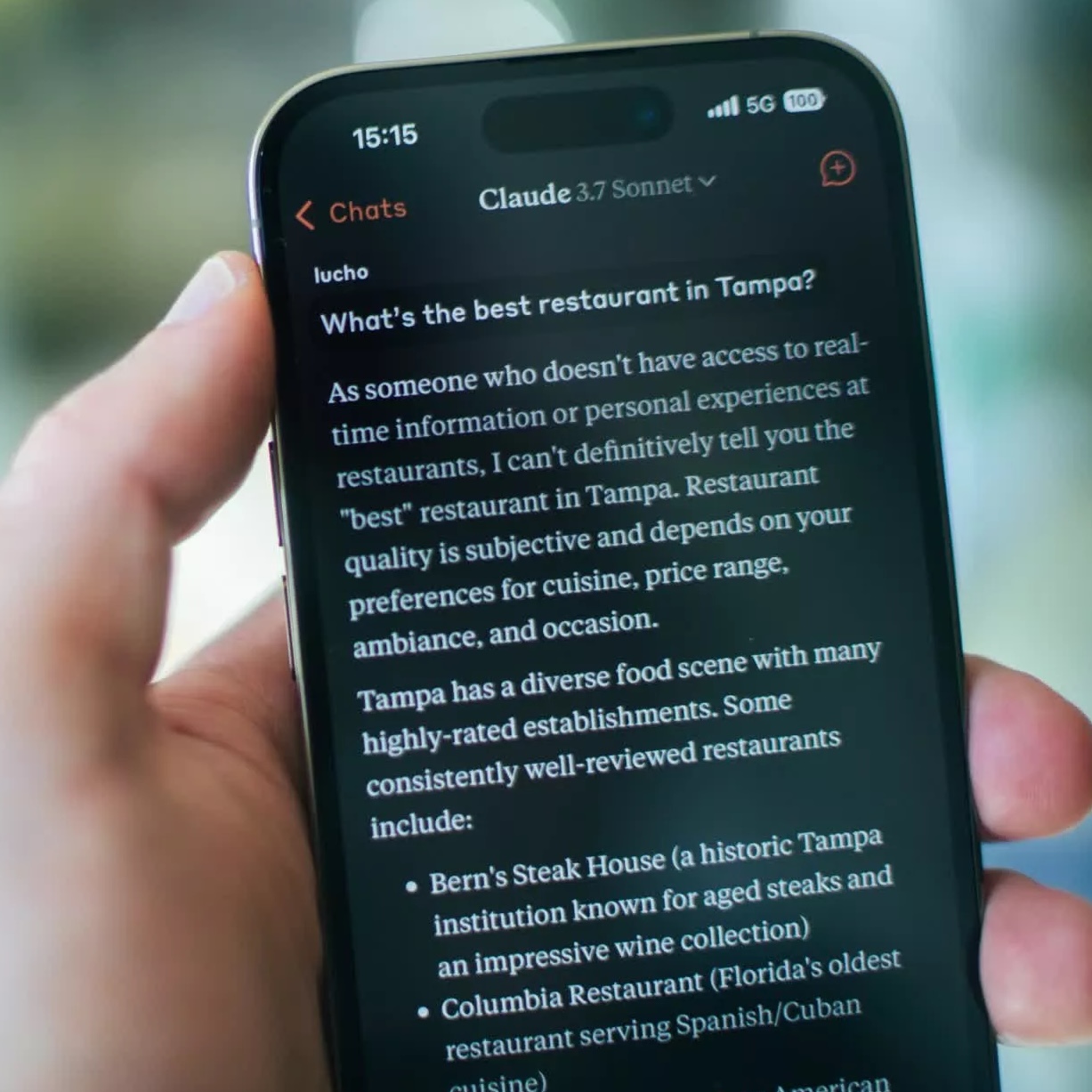 A phone showing a Claude chat interface.